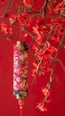 Decorative firecracker with background of ginkgo branch in chinese new year. Lunar New Year holidays