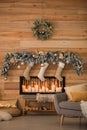 Decorative fireplace with Christmas stockings in room interior Royalty Free Stock Photo