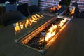 Decorative fireplace in heat resistant glass cage built into larger dining table, as displayed on Furniture and Living expo