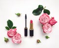 Decorative flat lay composition with cosmetics and flowers. Top view on white background