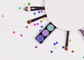 Decorative flat lay composition with makeup products, cosmetics and glass jars with decorative multi-colored stars. Flat Royalty Free Stock Photo