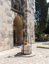 Decorative flower bed framed with a metal frame with a cross in the yard of Pools of Bethesda in the old city of Jerusalem, Israel Royalty Free Stock Photo