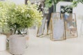 Decorative flowers, candles and dried plants in frame on dressing table. Close-up of bedroom interior details Royalty Free Stock Photo