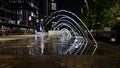 The decorative fountains at Lewis Cubitt Square near Coal Drops Yard at night