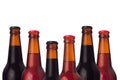 Decorative frame of set head beers bottles with porter, ale, lager beer and water drops isolated on white background.