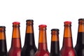 Decorative frame of set head beers bottles with porter, ale, lager beer and water drops isolated on white background. Royalty Free Stock Photo