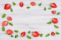 Decorative frame of strawberry and mint leaf on white background with copy space, top view. Royalty Free Stock Photo