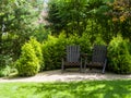 Decorative garden. A secluded corner with stylish wooden chairs