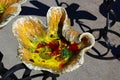 Decorative garden stand made of coloured twisted metal plate, painted like a yellow flower with colorful, crystallic center.