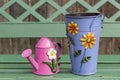 Decorative garden watering can and bucket on a wooden bench. Rustic style Royalty Free Stock Photo