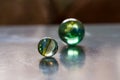 Decorative glass balls of different size reflecting light on icy surface. Royalty Free Stock Photo