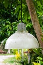 Decorative glass lanterns hanging in the garden under the tree Royalty Free Stock Photo