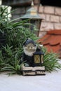 Decorative gnome with a lantern in the garden