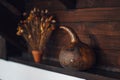 Decorative gourd perched on a shelf with a complementary potted plant featuring vibrant flowers. Royalty Free Stock Photo