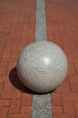 decorative granite ball sphere on sidewalk Royalty Free Stock Photo