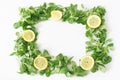 Decorative green vegetable frame composition. Various salad leaves. Arugula, rocket, corn salad with sliced lemons Royalty Free Stock Photo