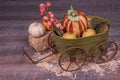 Decorative green wagon welcoming fall with fruits , pumpkins and