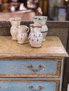 Decorative Handmade Porcelain Vases on top of an Antique Wooden Furniture