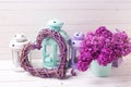 Decorative heart, lilac flowers and brigh lanterns on white wo