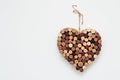 Heart made of wine corks isolated on white wall
