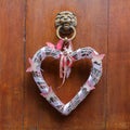 Decorative heart at an old doorknocker Royalty Free Stock Photo