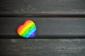 Decorative Heart with rainbow stripes on dark wooden background. LGBT pride flag, symbol of lesbian, gay, bisexual, transgender Royalty Free Stock Photo