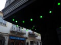 Decorative illumination in the restaurant. Green lamps. A chain of light bulbs against the sky. Cozy place