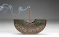 A decorative incense holder with a semi-circular shape features intricate floral patterns Royalty Free Stock Photo