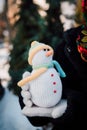 Decorative knitted snowman in women's hands Hand Made