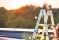 Photo of decorative ladder with lights against sunset at rooftop