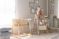 Decorative ladder with toys and different stuff in stylish baby room. Idea for interior design