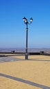 A Decorative Lamp Post Stands On A Mountain In The City Of Kerch Against The Background Of The Black Sea And Blue Sky