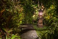 Decorative lamp on the stone pillar next to the path in the tropical garden at night . Island Bali, Indonesia . Nature concept Royalty Free Stock Photo