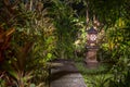 Decorative lamp on the stone pillar next to the path in the tropical garden at night . Island Bali, Indonesia . Nature concept Royalty Free Stock Photo