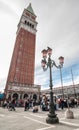 Decorative lampposts in Piazza San Marco against campanile. Royalty Free Stock Photo