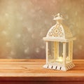 Decorative lantern with glowing candle on wooden table with copy space. Christmas celebration