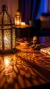 Decorative lantern with intricate patterns casting warm light and shadows on table with snacks and tea Royalty Free Stock Photo