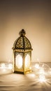Decorative lantern with string lights on table against plain background Royalty Free Stock Photo