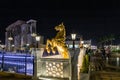 Decorative large full size gilded horse statue on a pedestal in the Global Village near Dubai city, United Arab Emirates