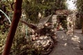 A decorative large stone bird holding a snake in its claws in a garden on exhibition in the Gardens Almona collection, in the rays