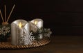 Decorative LED candles and snowflakes on wooden table, space for text Royalty Free Stock Photo