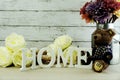 Decorative letters word home with peony flowers on wooden background Royalty Free Stock Photo