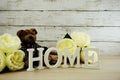 Decorative letters word home with peony flowers on wooden background Royalty Free Stock Photo