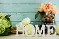 Decorative letters word home with peony flowers on wooden background Royalty Free Stock Photo