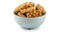 A decorative light blue ceramic bowl holds several pieces of peanut brittle, a Royalty Free Stock Photo