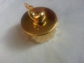 The decorative little golden pot with dolphin lid open, for room decoration