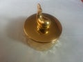 The decorative little golden pot with dolphin lid open, for room decoration