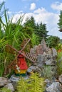 A decorative little windmill in a garden