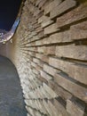 Decorative long brick wall in rounded perspective. The brick is laid out in a multi-level pattern