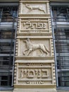 Decorative marble architectural elements of facade of an old building. Relief image. Fragment of metal gratings.